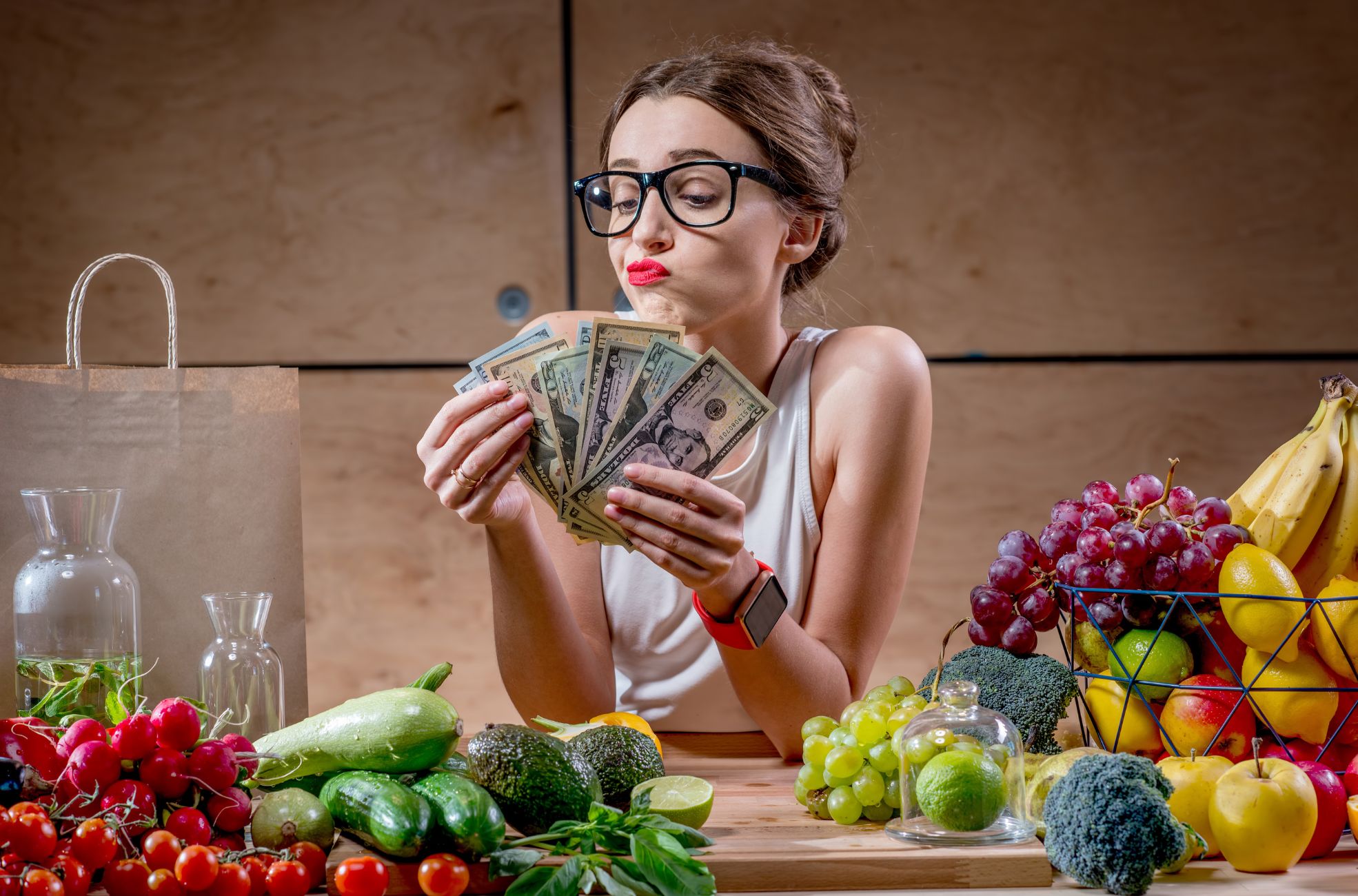 Woman Counting Money Next To Food