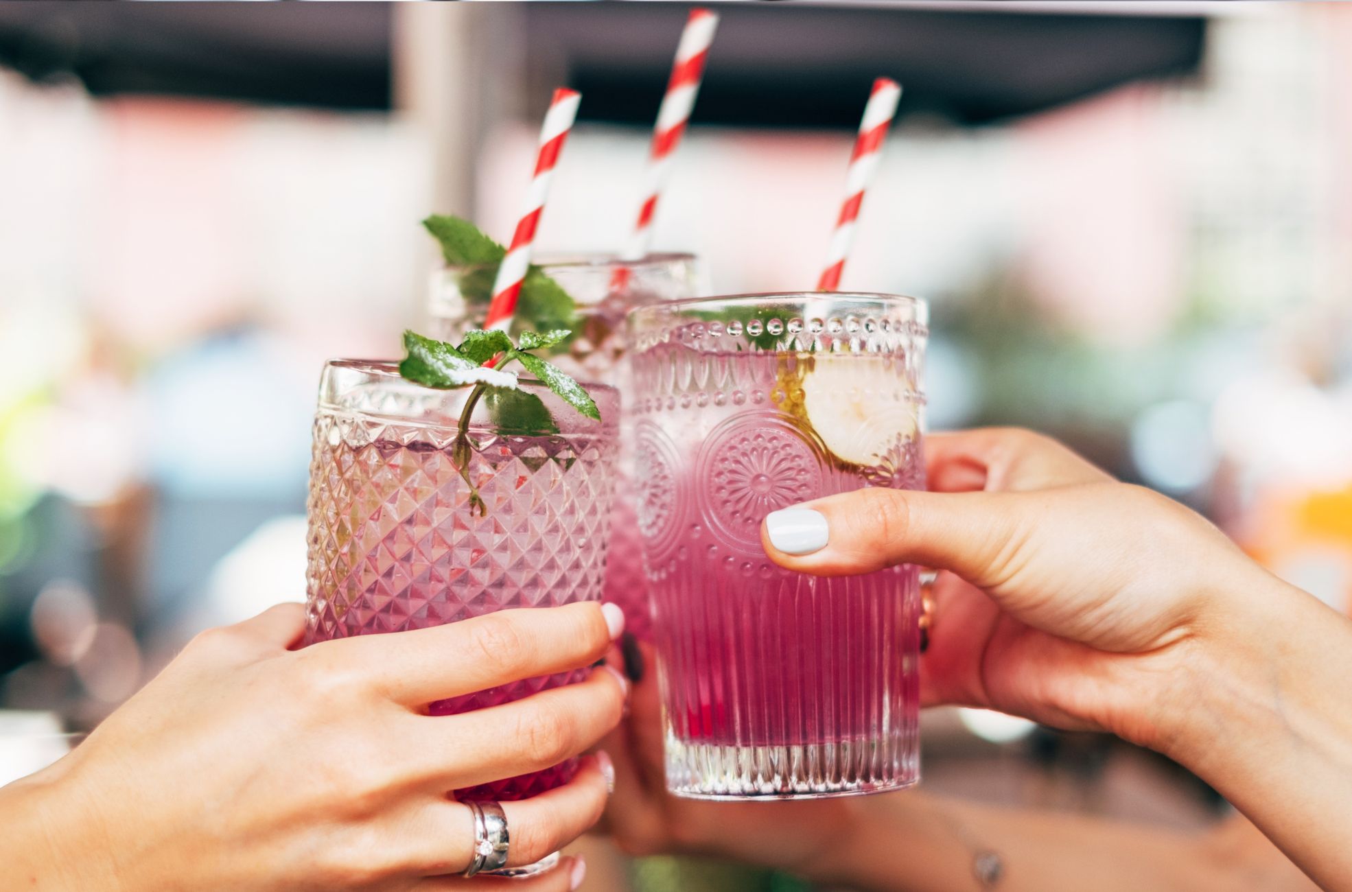 People Holding Cocktail Glasses