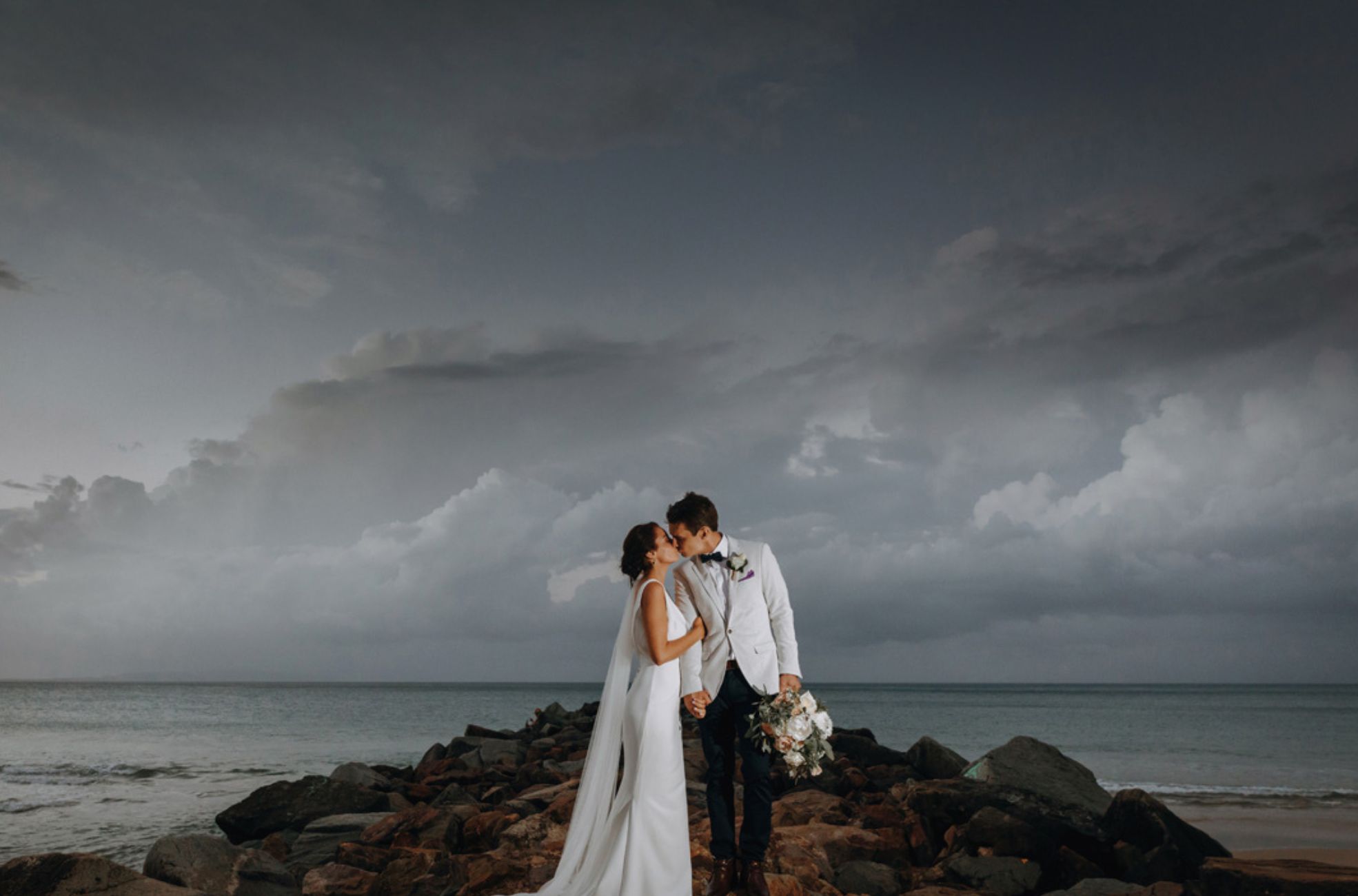 Wedding Couple Kissing On Rocks At Sunshine Coast