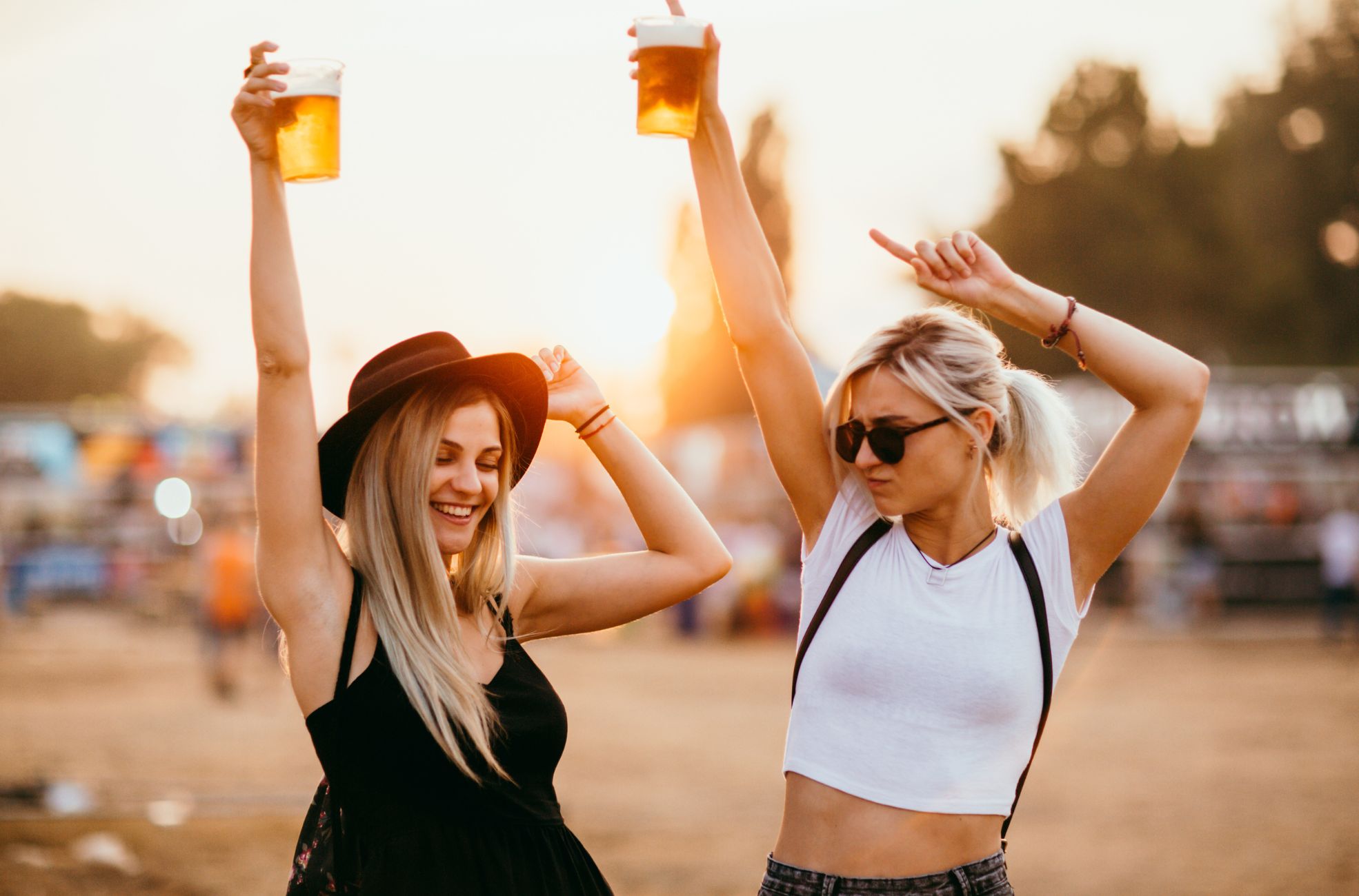 Women Enjoying Drinks In Coachella Clothing