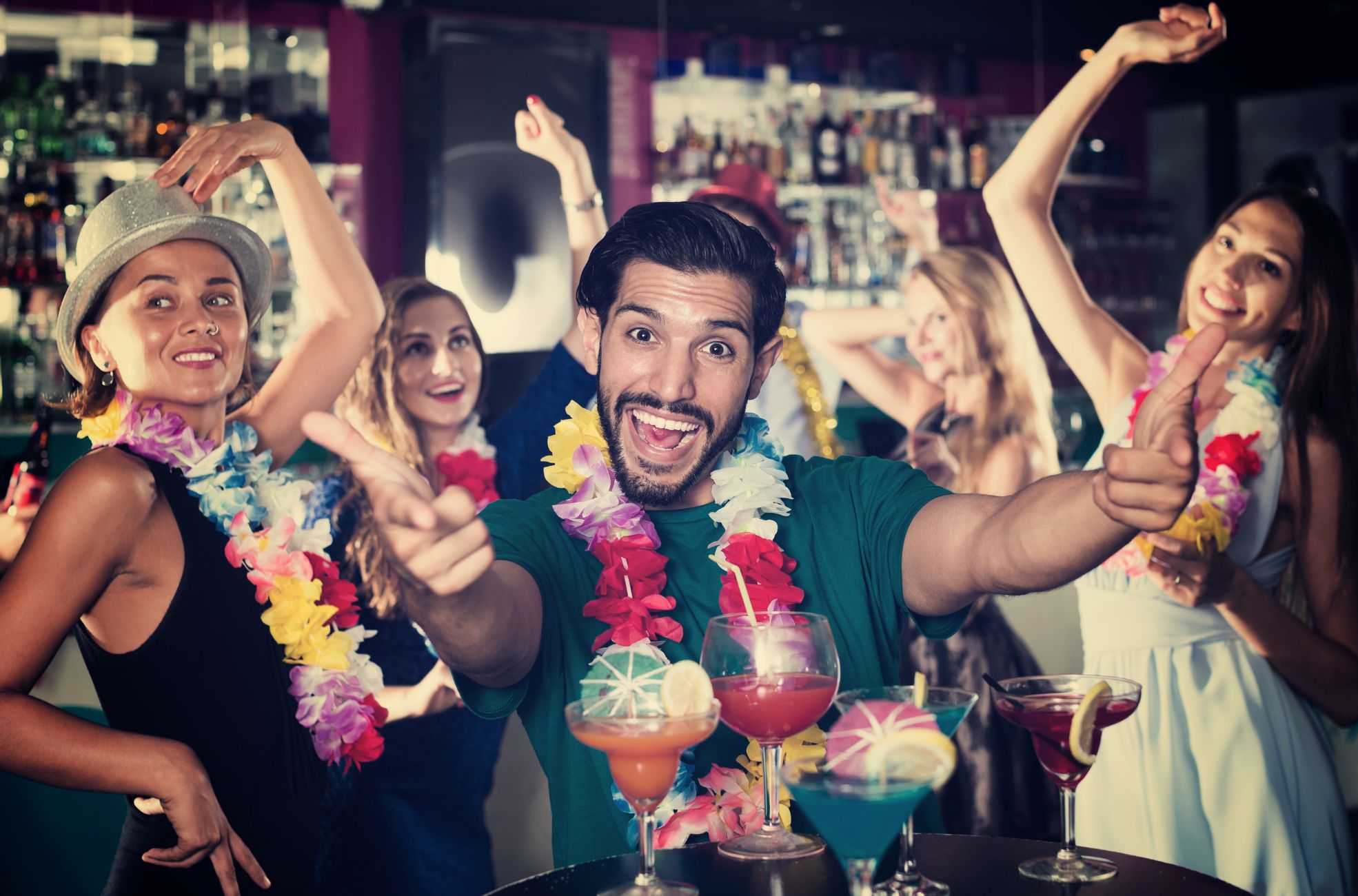 People Enjoying A Hawaiian-Themed Party