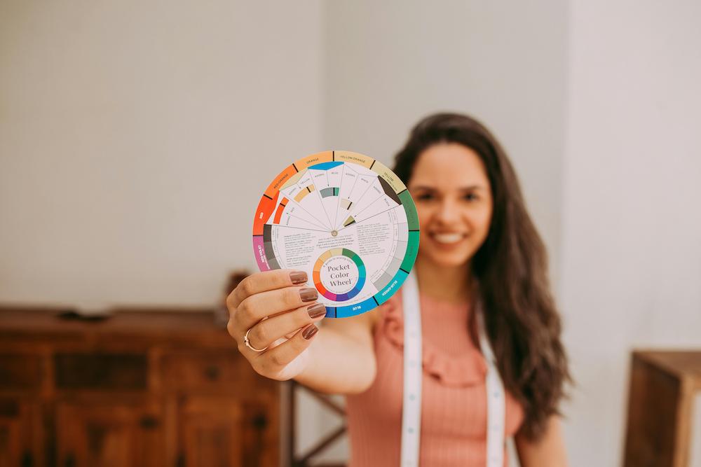 Girl holding a colour wheel which can inform choices based on colour psychology