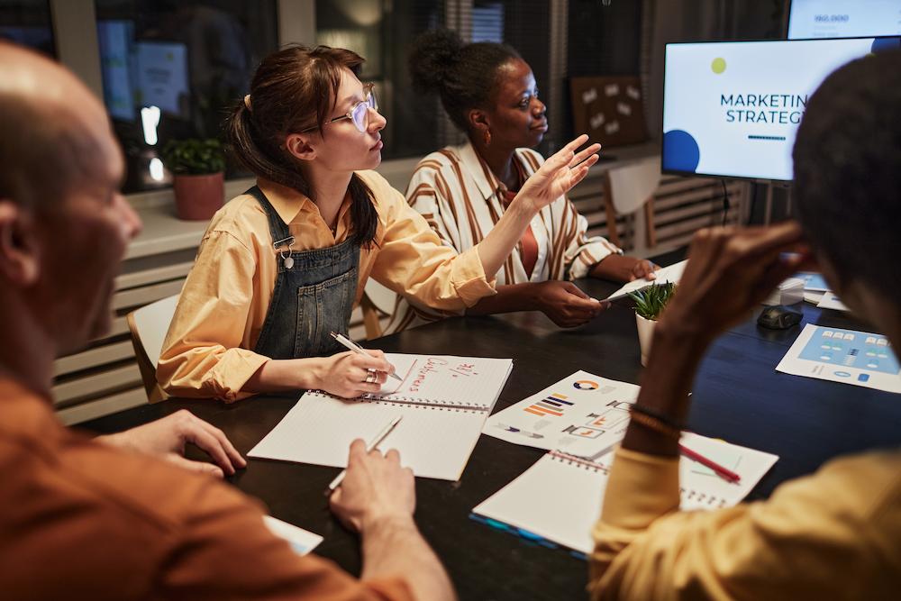 Business people around a boardroom table working on an event collaboration