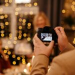 A man holding a camera and taking a photo of guests at the event while employing creative event photography ideas