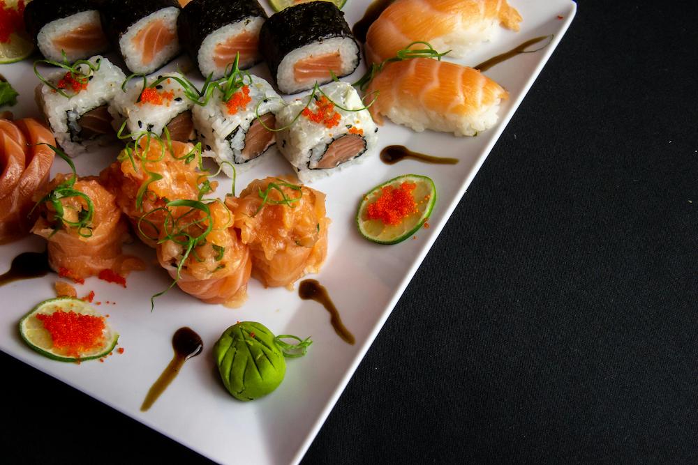 Selection of sushi on a plate on a food station at an event