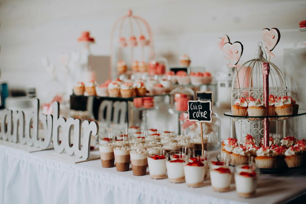 Sweet food station featuring cupcakes and other single servings of dessert