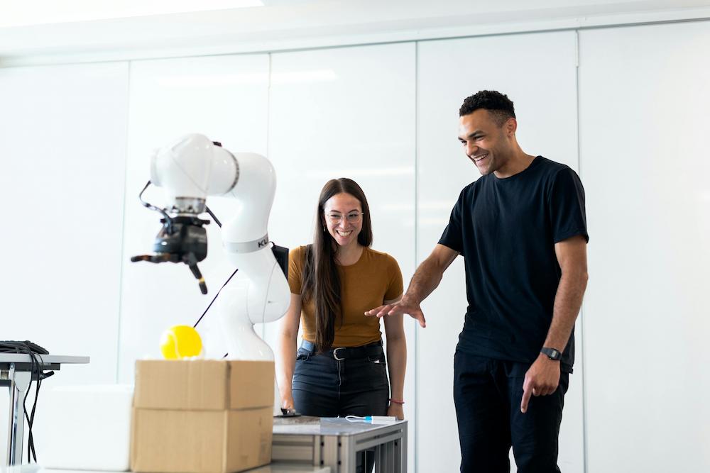 Two people at a robotics display