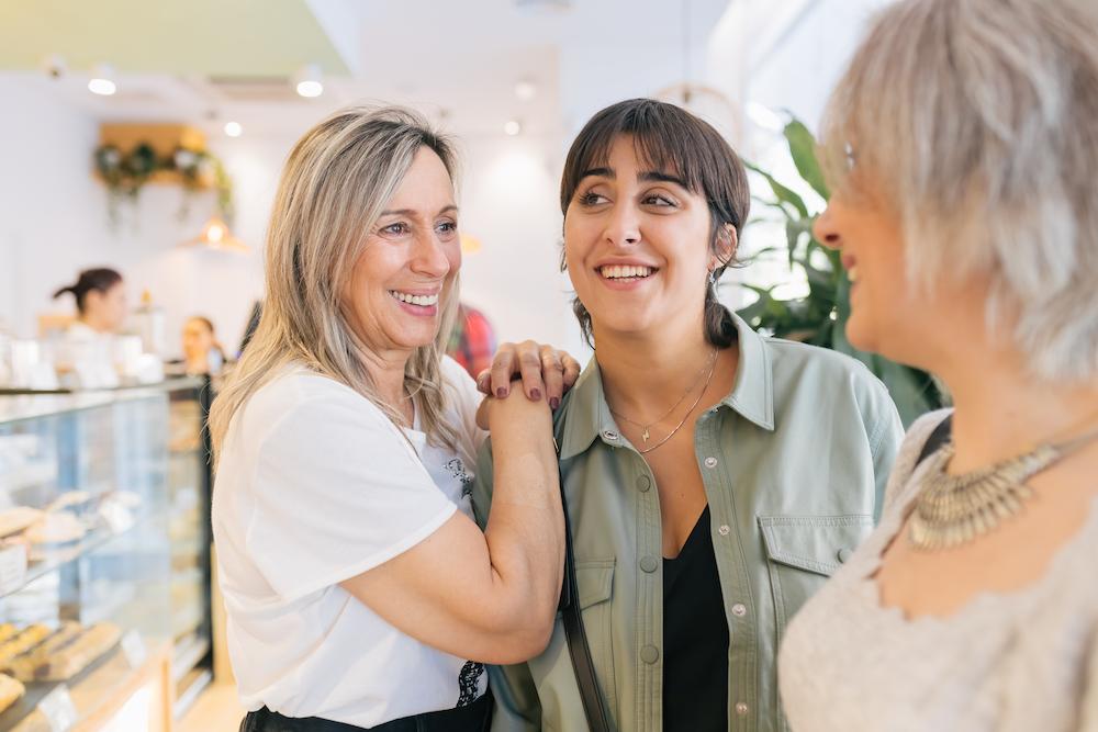 Two female business owners looking happy after a successful event collaboration