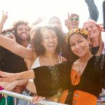 Group of young people at a festival enjoying a sunny day at outdoor events