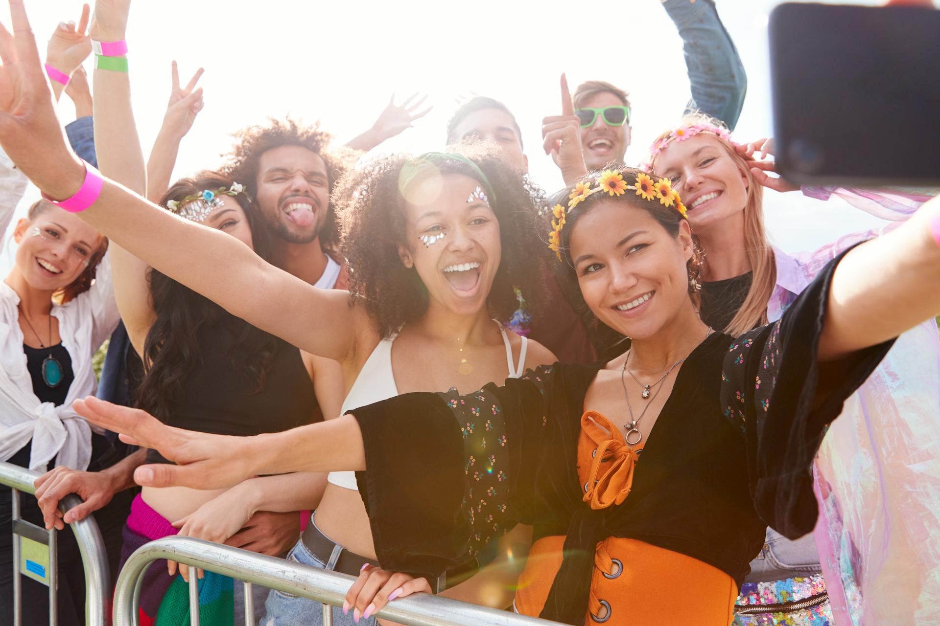 Group of young people at a festival enjoying a sunny day at outdoor events