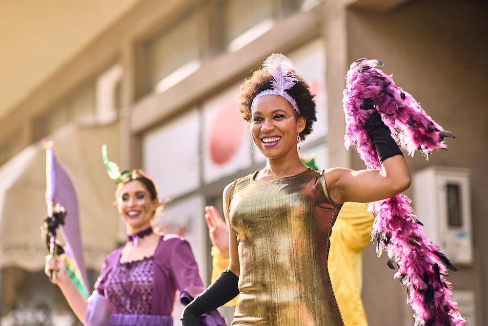 Outdoor events include parades or street carnivals such as the one these young woman are dressed up for