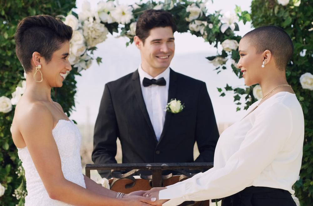 Two brides during their wedding ceremony with a male celebrant at one of the best wedding venues in perth