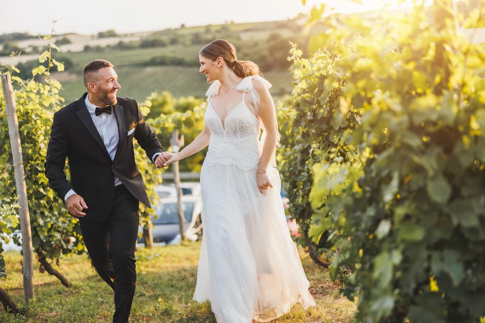 Bride and groom running through the vineyard at one of the most beautiful wedding venues in Perth 