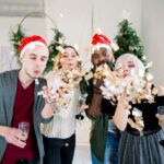 Work Christmas Party Ideas in Sydney include getting together like these four colleagues and drinking champagne while wearing santa hats