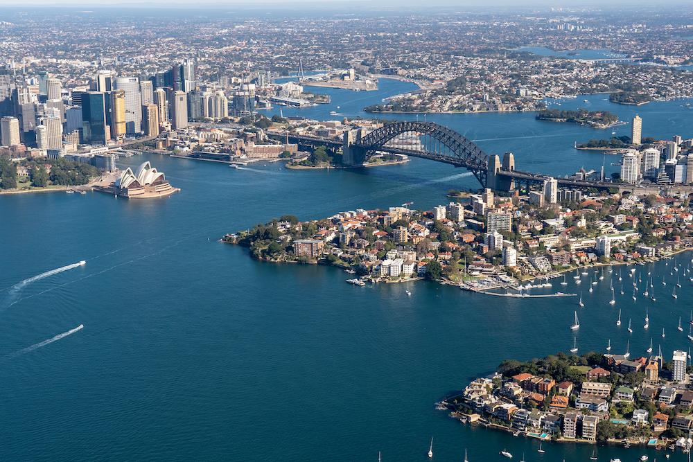 Work Christmas Party Ideas in Sydney include sailing on the harbour which you can see in this aerial shot of Sydney harbour including the bridge and the opera house