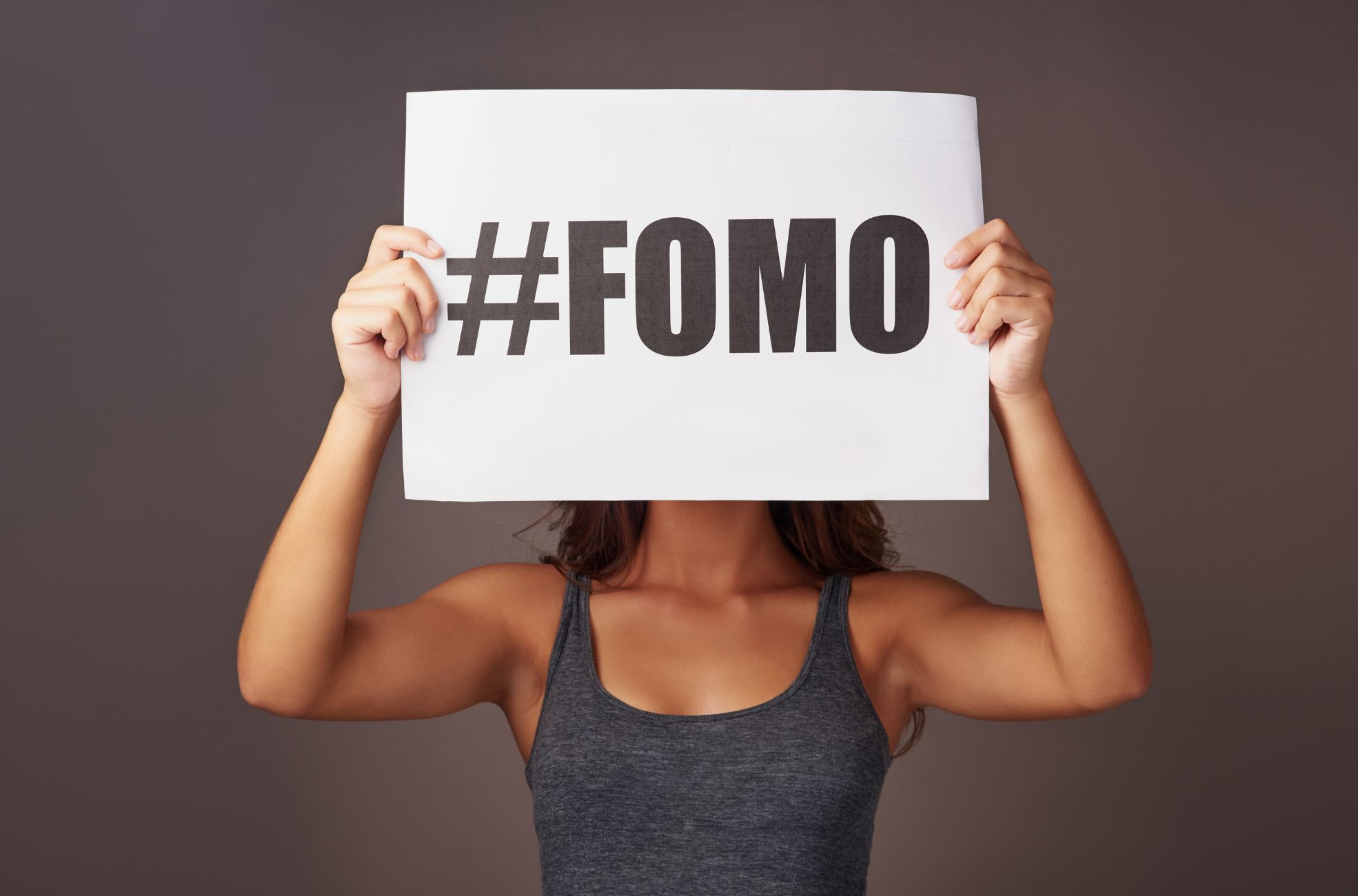 Woman Holding #FOMO Sign