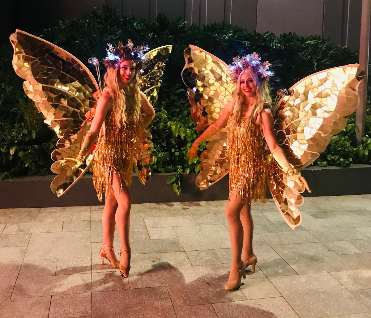 Two women dressed as butterflies.